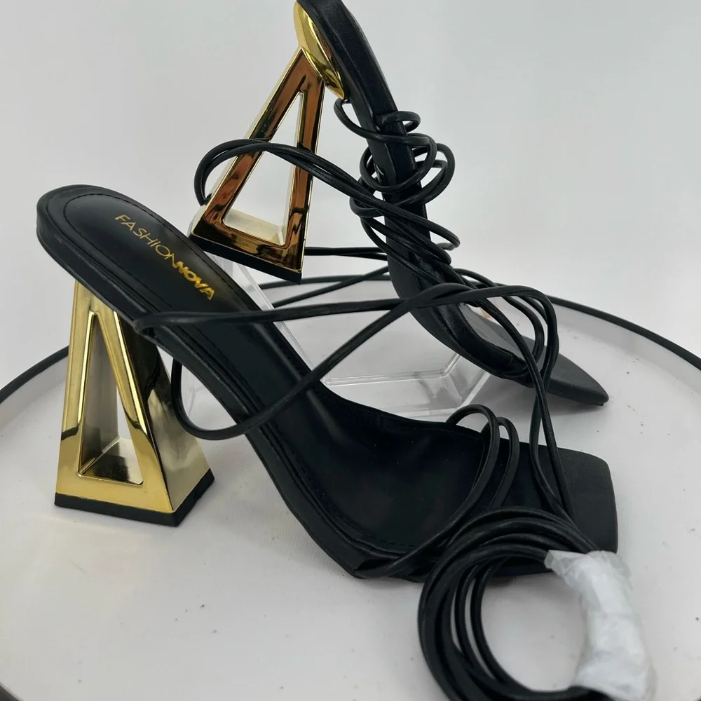 FASHION NOVA STAY WINNING WRAP UP HEELS ‎ IN BLACK GOLD NOVELTY HEELS